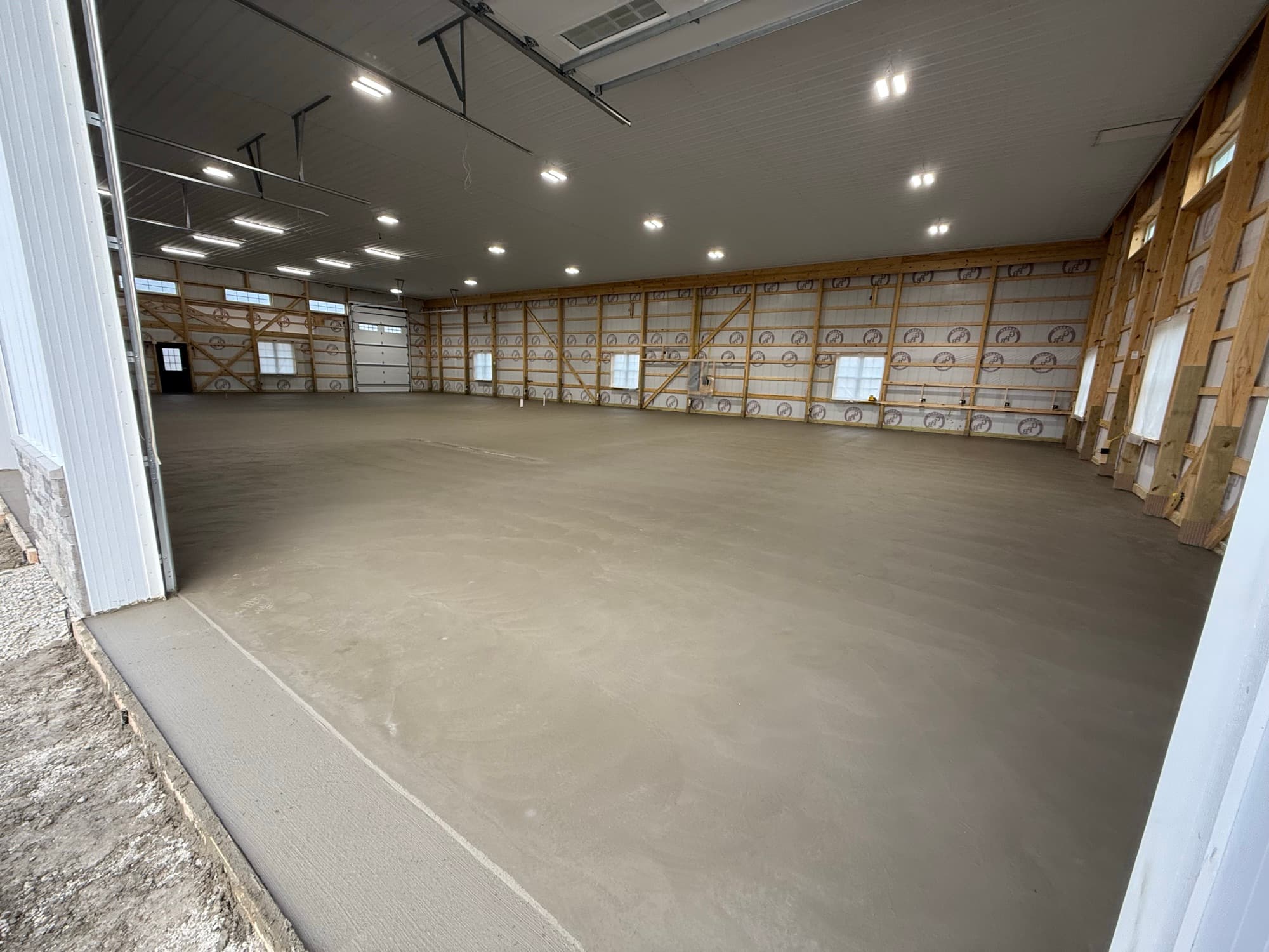 Finished interior concrete floor inside a post-frame commercial building